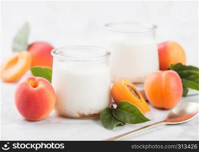 Fresh cream dessert with raw organic apricots on wooden board.