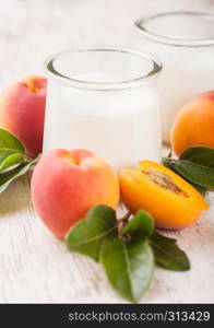 Fresh cream dessert with raw organic apricots on wooden board.