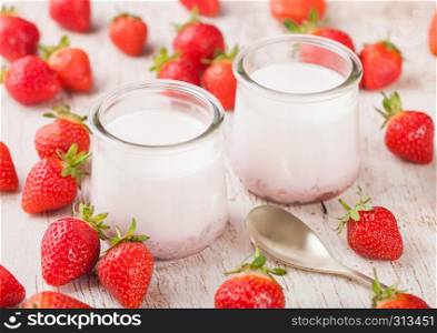 Fresh cream dessert with raw organic strawberry on wooden board. French style yogurt