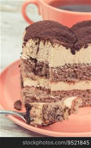Fresh creamy tiramisu cake with different layers and black coffee. Concept of delicious dessert for celebrations. Creamy tiramisu cake with different layers and black coffee. Delicious dessert for celebrations