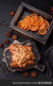 Fresh crispy croissant with almond chips and chocolate filling on a dark concrete background