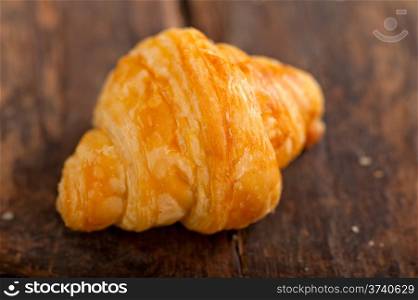 fresh croissant french brioche over old wood table