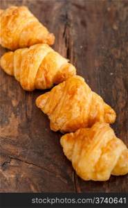 fresh croissant french brioche over old wood table
