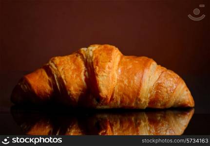 Fresh Croissant Isolated on a mirror surface