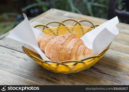 fresh croissant on plastic basket