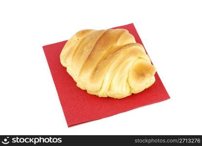 fresh croissant with red napkin isolated on white background