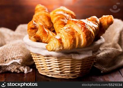 fresh croissants on wooden table