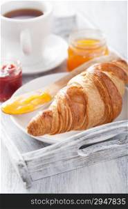 fresh croissants with jam for breakfast on tray