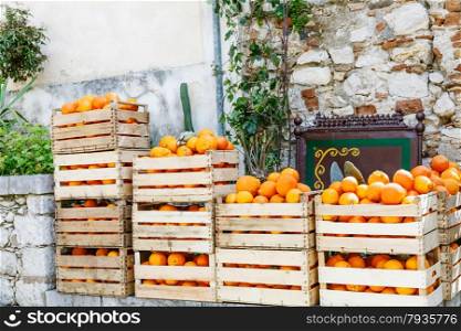 fresh crop of oranges in wooden boxes on a street market in Taormina town, Sicily, Italy in spring