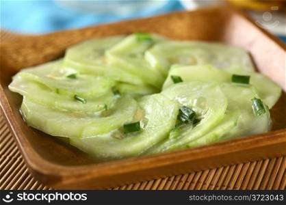 Fresh cucumber salad with chives and a yogurt dressing (Selective Focus, Focus on the chives in the front) . Cucumber Salad with Chives