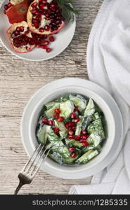 Fresh cucumber salad with dill and pomegranate kernels, in yoghurt sauce