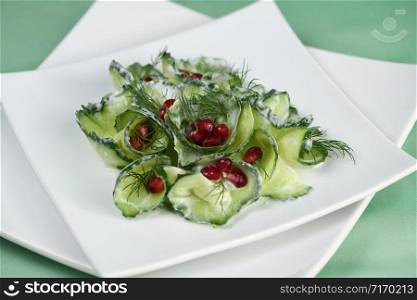Fresh cucumber salad with dill and pomegranate kernels, in yoghurt sauce