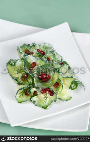 Fresh cucumber salad with dill and pomegranate kernels, in yoghurt sauce