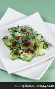 Fresh cucumber salad with dill and pomegranate kernels, in yoghurt sauce