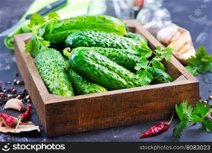 fresh cucumbers in box and on a table