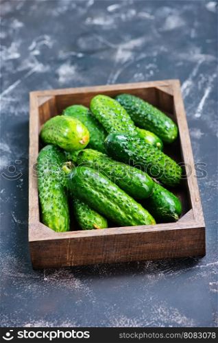 fresh cucumbers in box and on a table