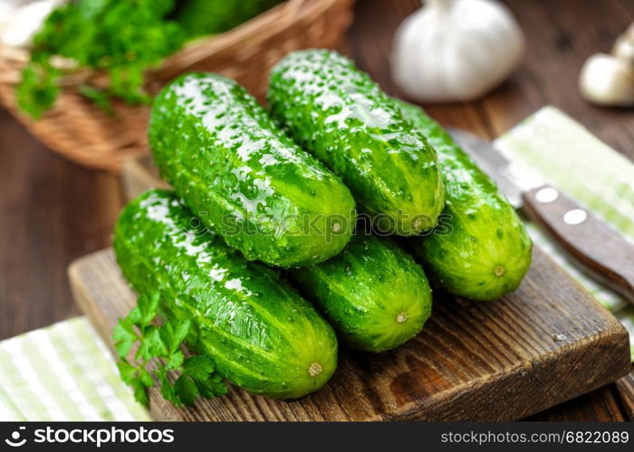 Fresh cucumbers on wooden background close up