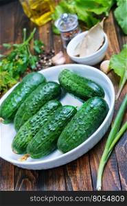 fresh cucumbers with salt and spice on the wooden table