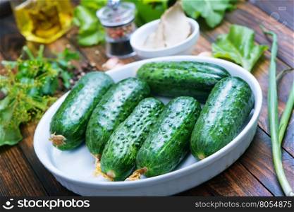 fresh cucumbers with salt and spice on the wooden table