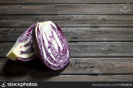 Fresh cut cabbage. On a wooden background.. Fresh cut cabbage.