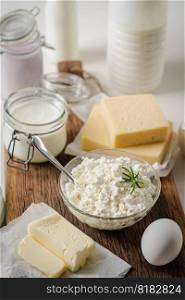Fresh dairy products, milk, cottage cheese, eggs, yogurt, sour cream and butter on kitchen table. Fresh dairy products