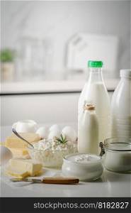 Fresh dairy products, milk, cottage cheese, eggs, yogurt, sour cream and butter on kitchen table. Fresh dairy products