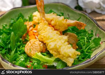 fresh deep fried Japanese tempura shrimps with salad and sea urchin