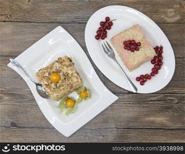 Fresh delicious diet cake with berry Physalis and red currant at Dukan Diet on a porcelain plate with a spoon on a wooden background.. Fresh delicious diet cake with berry Physalis and red currant at Dukan Diet on a porcelain plate with a spoon on a wooden background