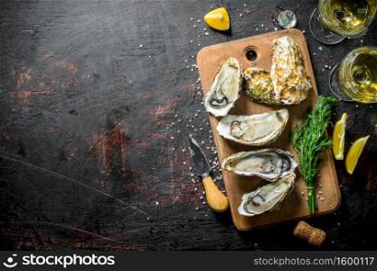 Fresh delicious oysters with white wine, lemon and dill. On dark rustic background. Fresh delicious oysters with white wine, lemon and dill.