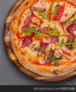 Fresh delicious pizza with three types of meat and sausage