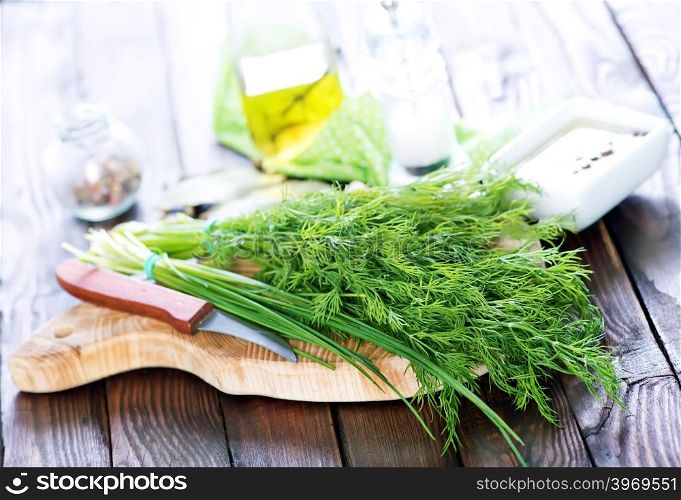 fresh dill on board and on a table