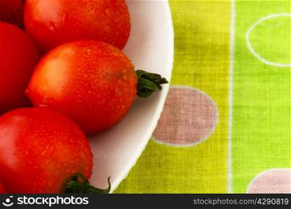 fresh domestic tomatoes in a white bowl