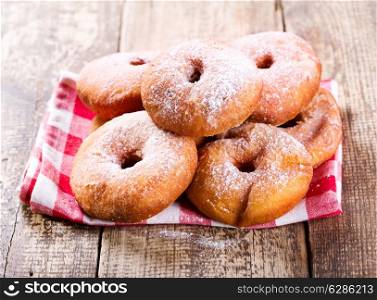 fresh donuts on wooden table