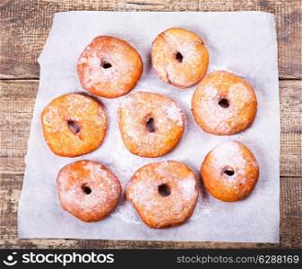 fresh donuts on wooden table