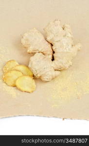 Fresh, dried and powdered ginger at brown background