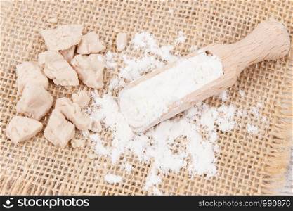 Fresh dry crumbled yeast and flour as ingredients for cooking and baking. Fresh crumbled yeast and flour as ingredients for baking or cooking