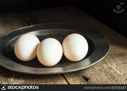 Fresh duck eggs in moody vintage style natural lighting set up. food, fresh, raw, fruit, vegetables, wood, wooden, background, grunge, retro, vintage, moody, dark,
