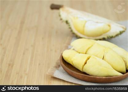 Fresh durian fruit on a wooden plate at the restaurant