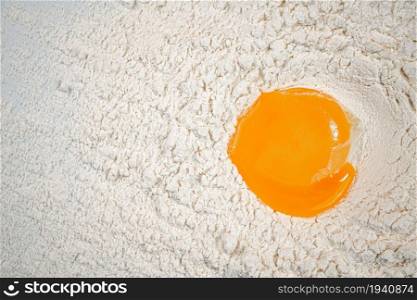 Fresh egg in a bunch of flour. On a white background.. Fresh egg in a bunch of flour.