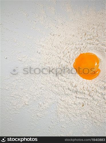 Fresh egg in a bunch of flour. On a white background.. Fresh egg in a bunch of flour.