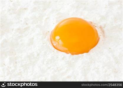 fresh egg yolk in the white flour