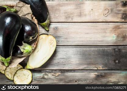Fresh eggplant in the basket. On wooden background. Fresh eggplant in the basket.