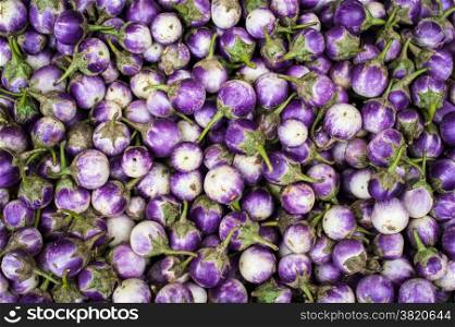 Fresh eggplants and for sale at asian market. Organic food background