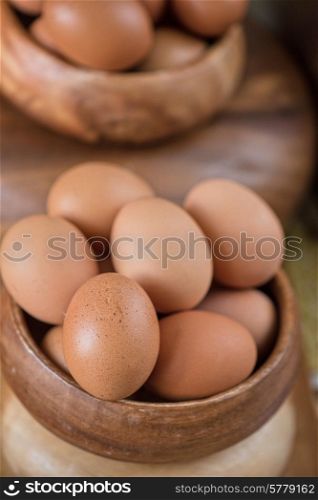 Fresh eggs at wooden plate closeup. Fresh eggs