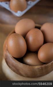 Fresh eggs at wooden plate . Fresh eggs at wooden plate closeup