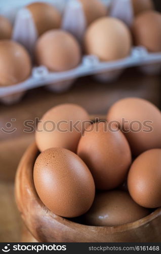 Fresh eggs at wooden plate . Fresh eggs at wooden plate closeup