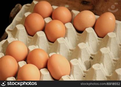 Fresh eggs in a carton box on a market stall