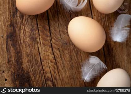 Fresh eggs on wooden table background with copy space. Top view