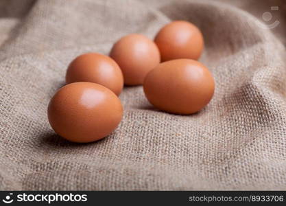 Fresh eggs scattered on sacking