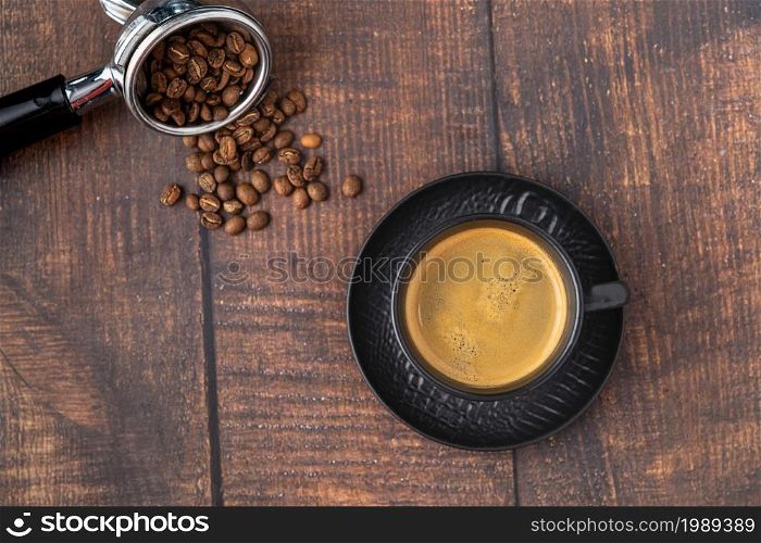Fresh espresso coffee together decorated with coffee beans on wooden table